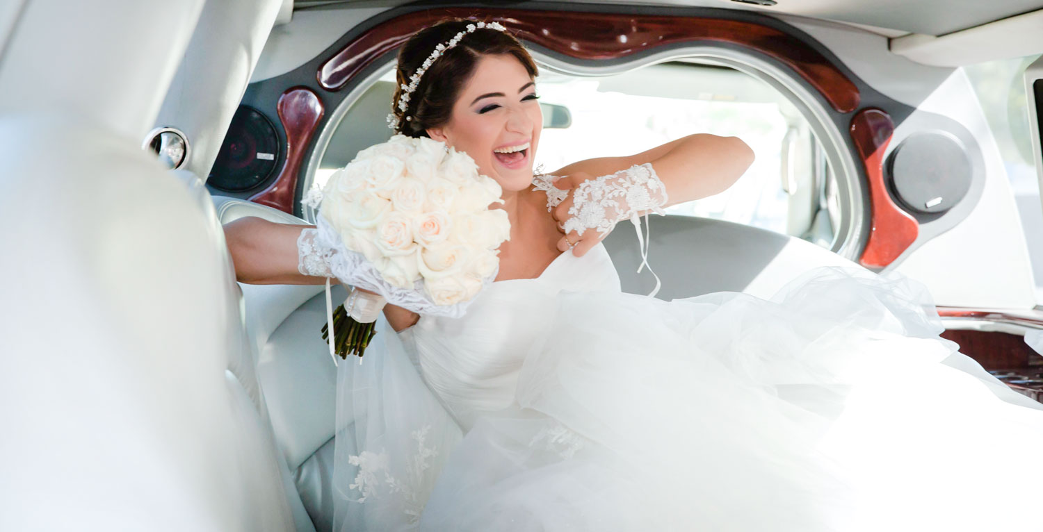 Cinematic portrait of a joyful bride in limousine after the matrimonial ceremony in Ville Saint-Laurent, Quebec.